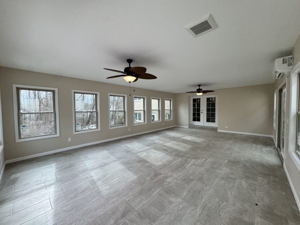 Painesville, Ohio This completed residential project added a sunroom and garage to an existing single-family home, expanding both living space and functionality with a seamless integration into the original structure, delivered through full preconstruction and construction management services.